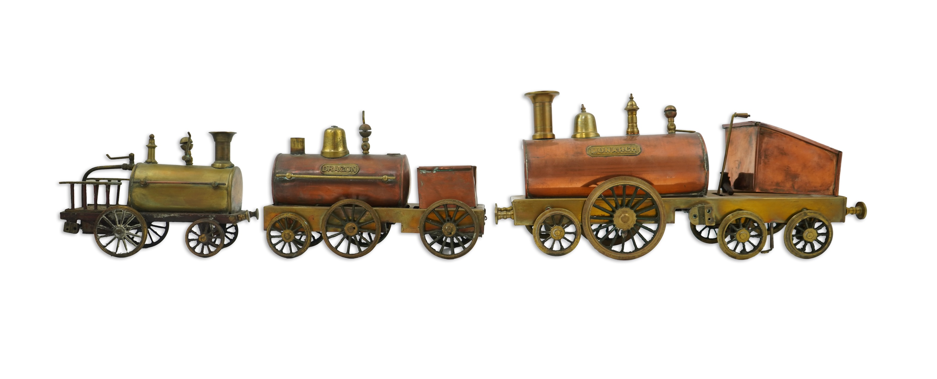 Three late 19th or early 20th century brass and copper live steam locomotives; a 2-2-4, ‘Monarch’, gauged to run on approximately 4 1/2 inch track, 33cm long frames, a 2-2-2, ‘Dragon’, gauged to run on approximately 3 1/